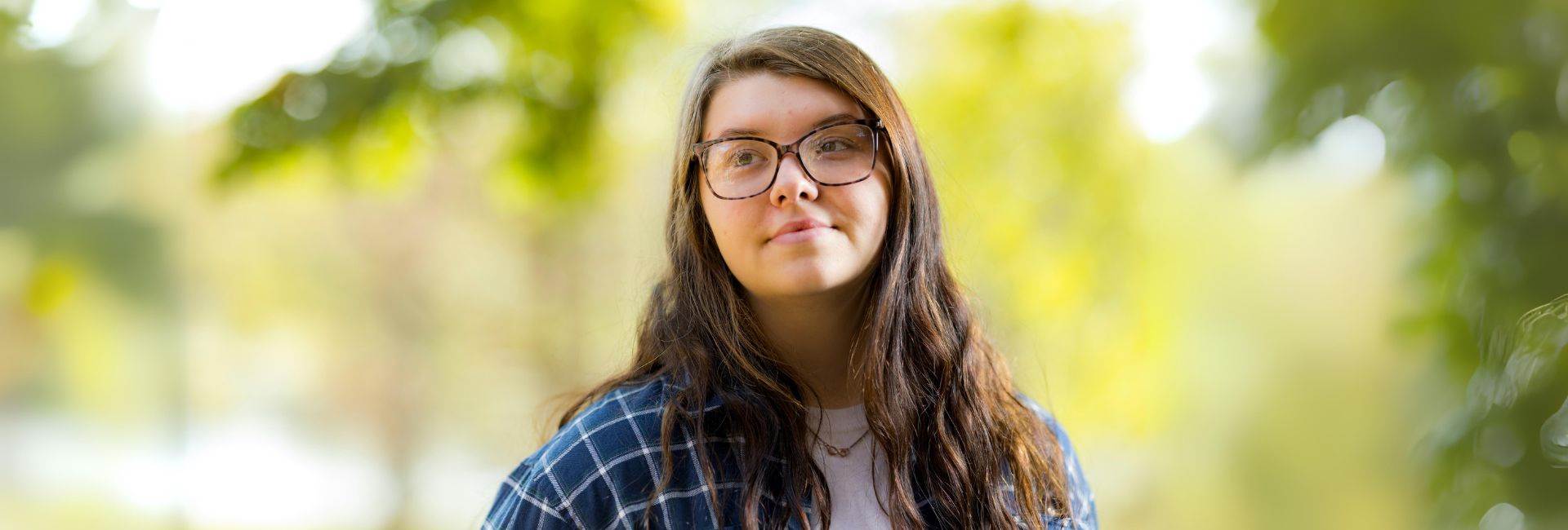 girl smiling and looking toward camera